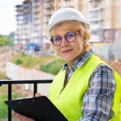 female-builder-worker-construction-site-works-controls-process.jpg